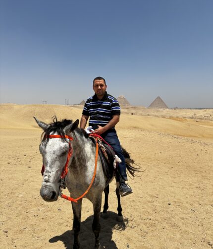 Tourist on horseback riding near the Pyramids of Giza in Cairo, Egypt
